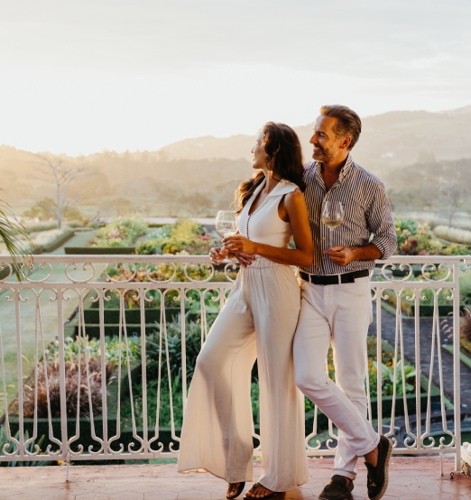 Couple enjoying sundowner cocktails at Le Château de Bel Ombre during sunset
